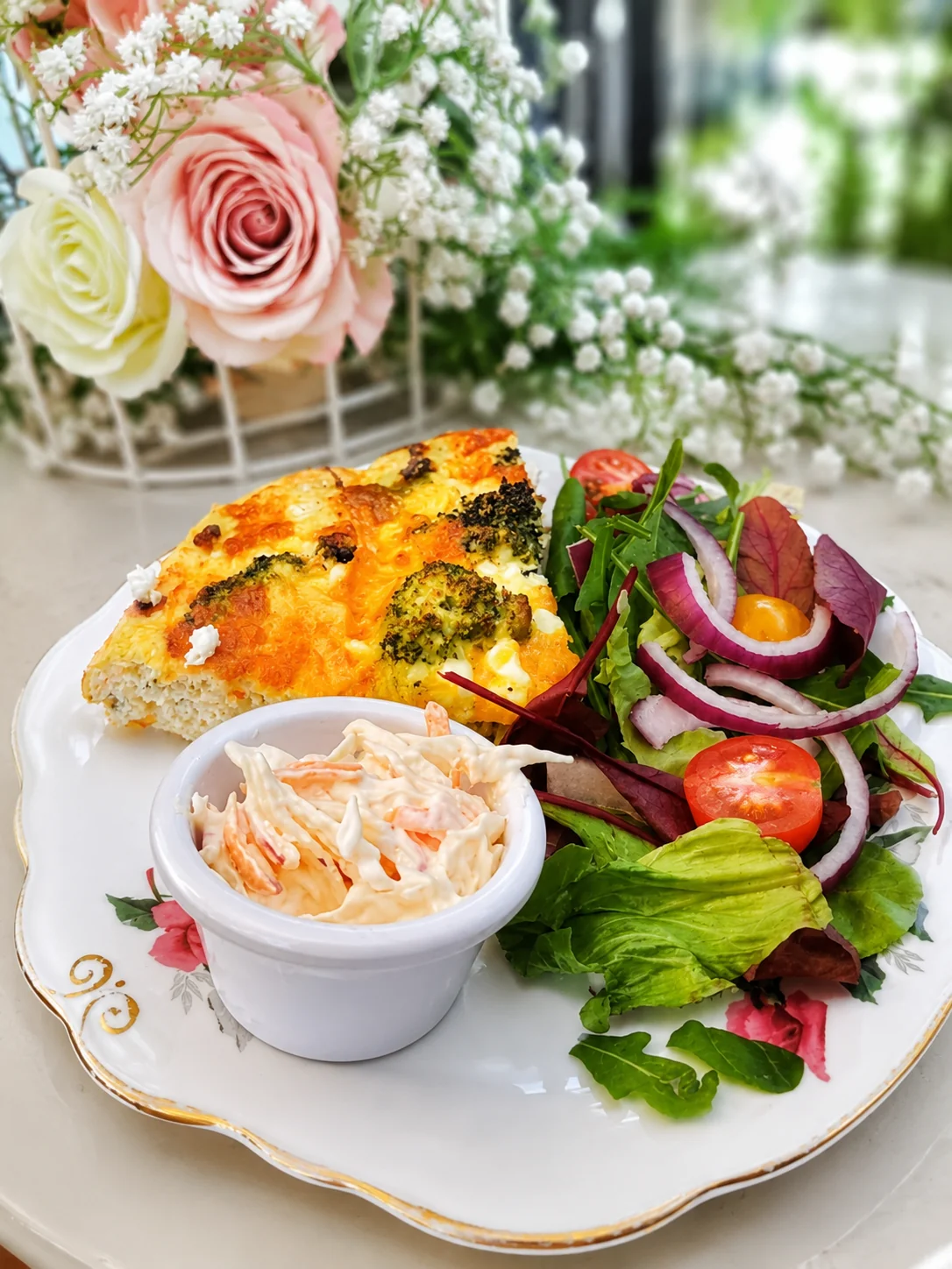 A savoury baked slice served with salad and coleslaw at Fifteas