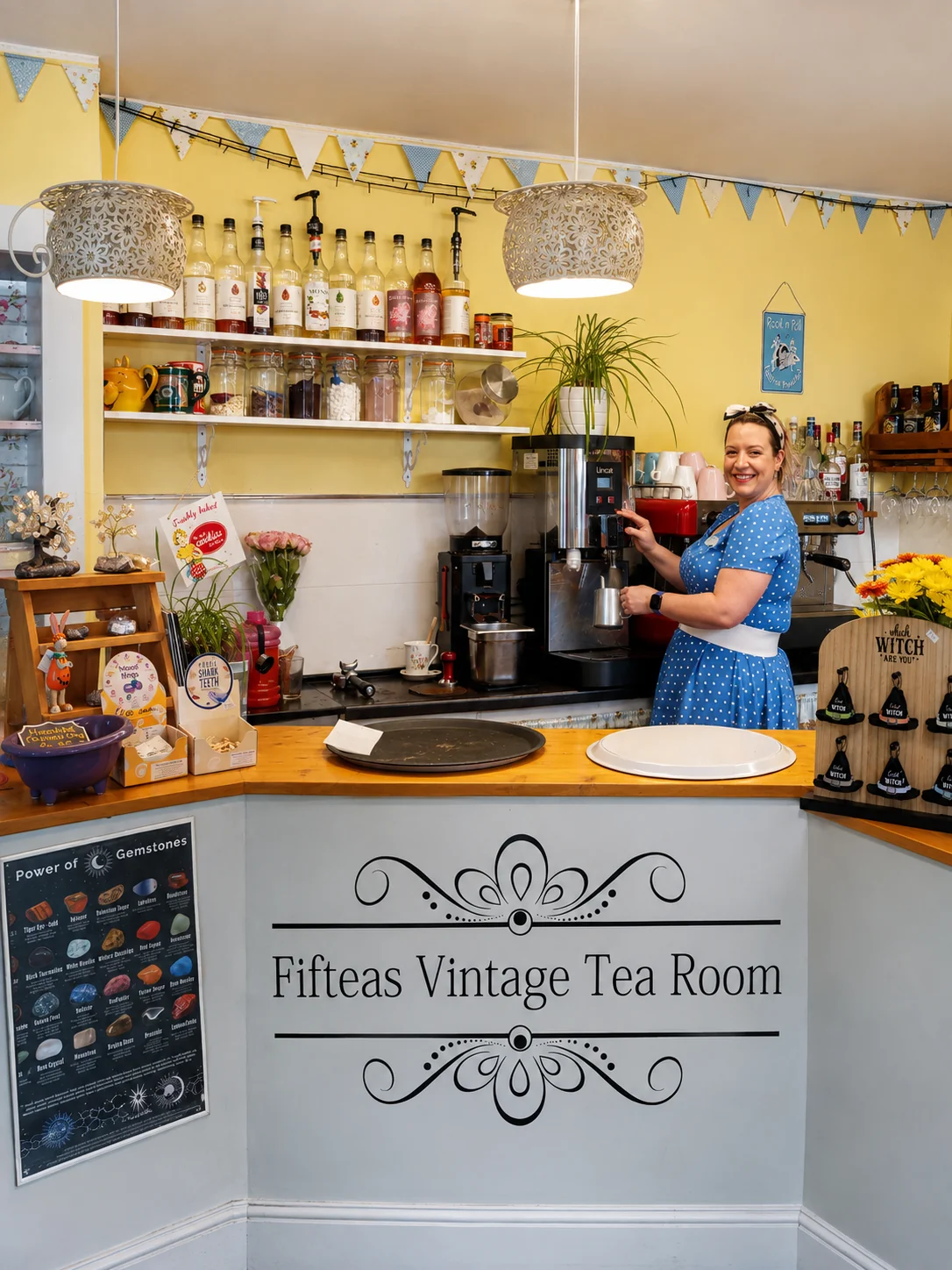 A smiling member of the Fifteas team behind the tea room counter